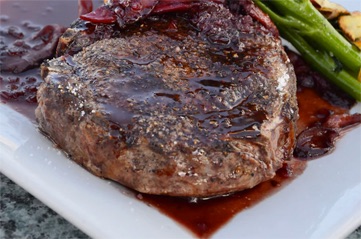 Well grilled steak in red wine reduction.