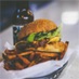 stacked chicken burger and potatoe wedges