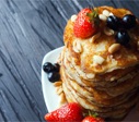 pancakes with berries stacked on top